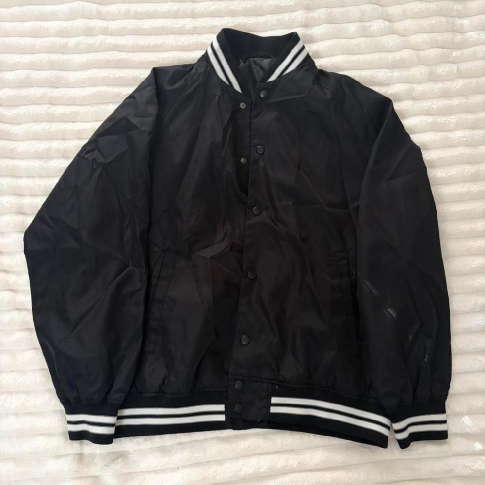 Black varsity jacket with white stripes